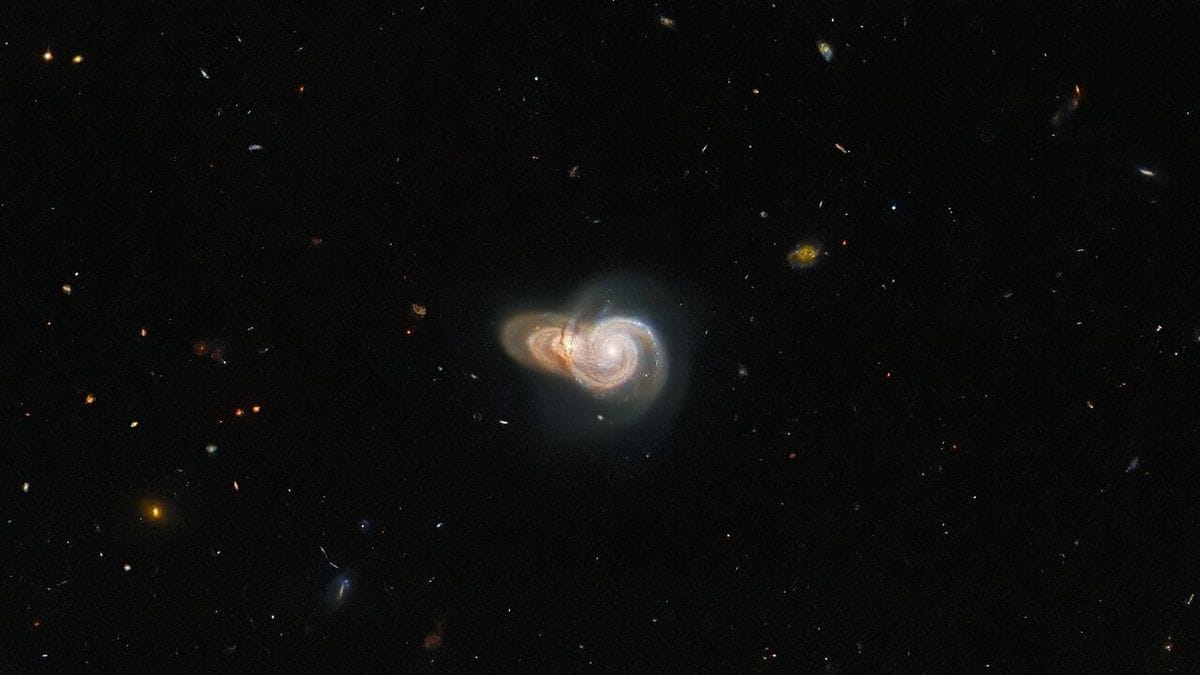 Unveiling a Cosmic Enigma: Hubble Captures Record 9-Ring Galaxy and Intergalactic Collision